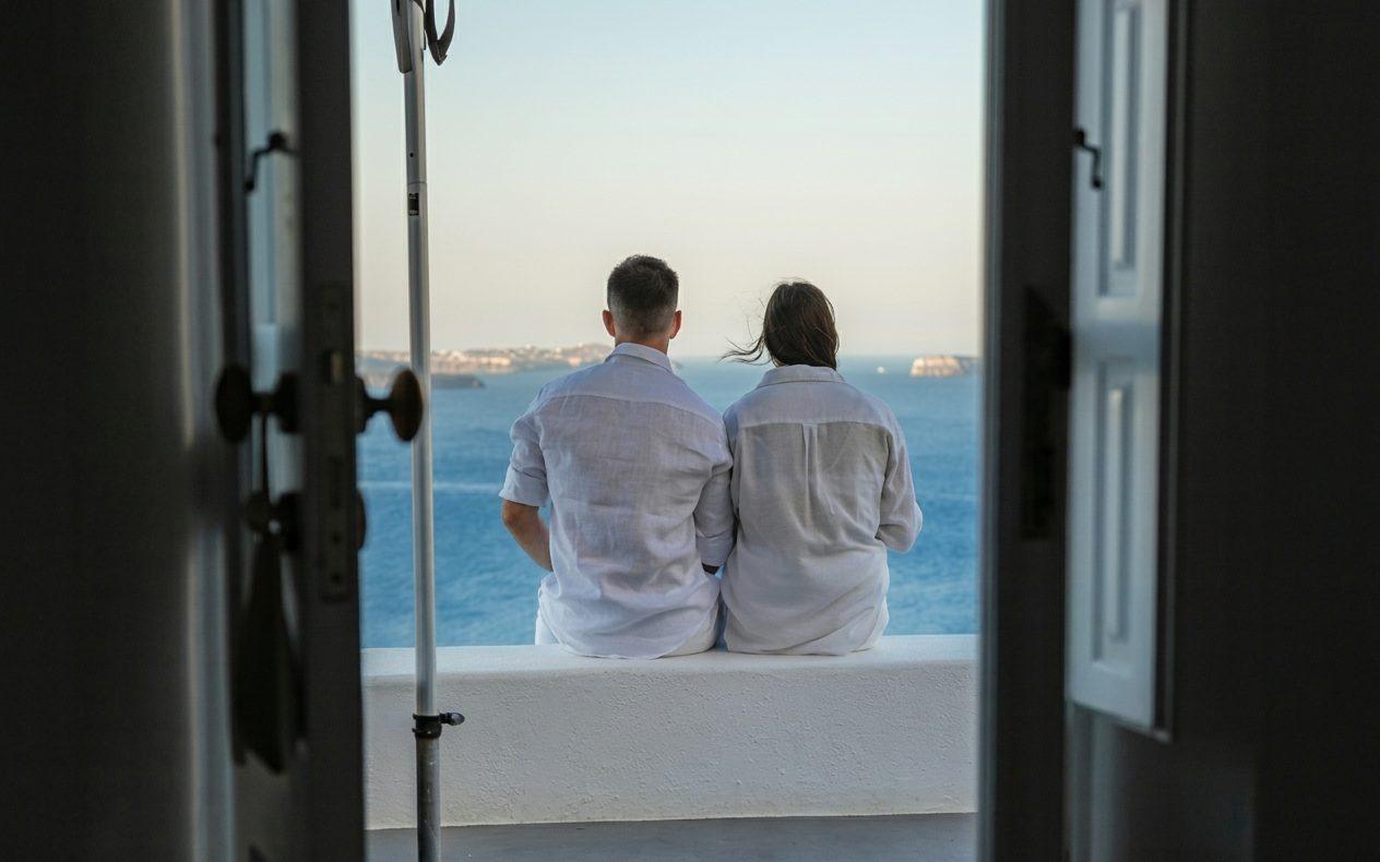 Couple looking out to sea from a terrace on the coast